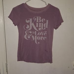 A purple T-shirt is a size 10/12 for girls.